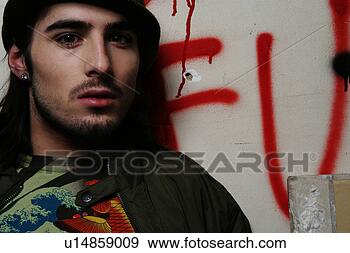 Stock Photograph - young man against 
a graffiti wall. 
fotosearch - search 
stock photos, 
pictures, images, 
and photo clipart