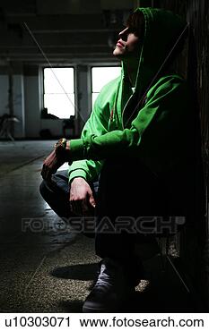 Stock Photography - young man crouched 
down. fotosearch 
- search stock 
photos, pictures, 
images, and photo 
clipart
