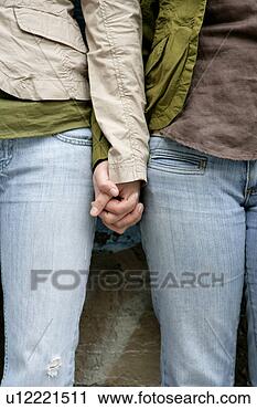 Stock Photography - view of two women 
holding of hands. 
fotosearch - search 
stock photos, 
pictures, images, 
and photo clipart