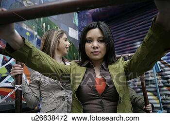 Stock Photo - view of two women 
happily. fotosearch 
- search stock 
photos, pictures, 
images, and photo 
clipart