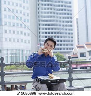 Stock Photo - portrait of a 
businessman eating 
a burger. fotosearch 
- search stock 
photos, pictures, 
images, and photo 
clipart
