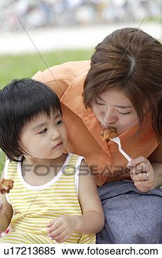 Stock Image - a mother and son 
eating fried chicken. 
fotosearch - search 
stock photos, 
pictures, images, 
and photo clipart