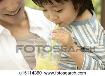 Stock Photography - a young boy makes 
bubbles out of 
the juice as his 
father holds him. 
fotosearch - search 
stock photos, 
pictures, images, 
and photo clipart