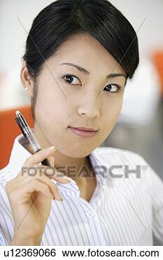 Stock Photo - a businesswoman 
holding a pen 
lost in her thoughts. 
fotosearch - search 
stock photos, 
pictures, images, 
and photo clipart