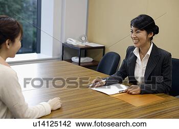 Stock Photo - two professional 
women sharing 
laughter in the 
office. fotosearch 
- search stock 
photos, pictures, 
images, and photo 
clipart