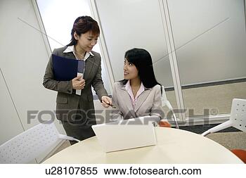 Stock Image - a woman points 
out on the screen 
of laptop as the 
other stares at 
her. fotosearch 
- search stock 
photos, pictures, 
images, and photo 
clipart