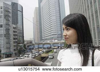 Stock Photo - a woman seen smiling 
in a commercial 
area. fotosearch 
- search stock 
photos, pictures, 
images, and photo 
clipart