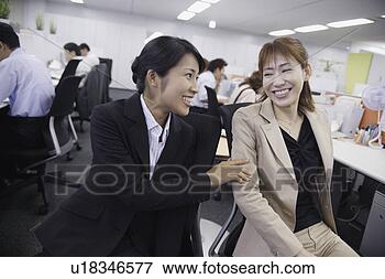 Picture - a woman sharing 
a joke with her 
colleague in the 
office. fotosearch 
- search stock 
photos, pictures, 
images, and photo 
clipart