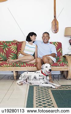 Stock Photo - a couple sitting 
on sofa. fotosearch 
- search stock 
photos, pictures, 
images, and photo 
clipart