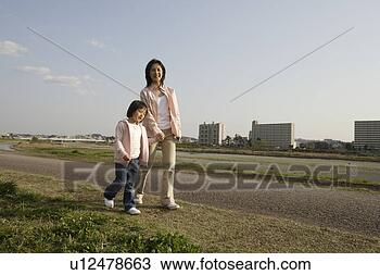 Stock Photo - view of a mother 
and daughter walking 
along pathway. 
fotosearch - search 
stock photos, 
pictures, images, 
and photo clipart