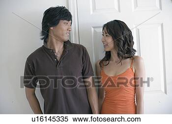 Stock Image - a young couple 
looking at each 
other. fotosearch 
- search stock 
photos, pictures, 
images, and photo 
clipart
