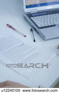 Stock Image - documents and 
notebook computer 
at desk. fotosearch 
- search stock 
photos, pictures, 
images, and photo 
clipart