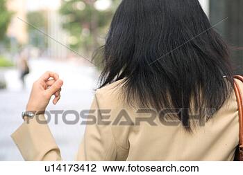 Stock Photo - a young businesswoman 
walking, rear 
view. fotosearch 
- search stock 
photos, pictures, 
images, and photo 
clipart