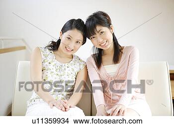 Stock Photo - two young women 
looking at camera. 
fotosearch - search 
stock photos, 
pictures, images, 
and photo clipart