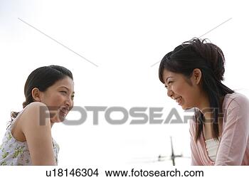 Stock Photo - two young women 
smiling. fotosearch 
- search stock 
photos, pictures, 
images, and photo 
clipart