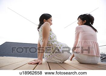 Stock Photo - two young women 
talking. fotosearch 
- search stock 
photos, pictures, 
images, and photo 
clipart