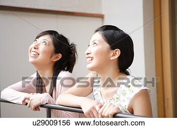 Stock Photo - two young women 
looking up. fotosearch 
- search stock 
photos, pictures, 
images, and photo 
clipart