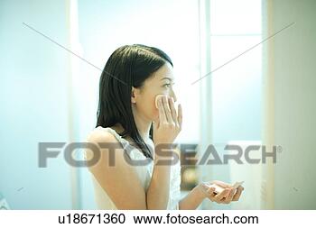 Stock Photography - young woman applying 
make-up. fotosearch 
- search stock 
photos, pictures, 
images, and photo 
clipart