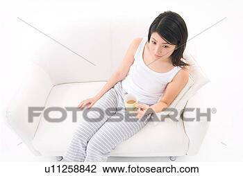 Stock Photo - young woman drinking 
coffee. fotosearch 
- search stock 
photos, pictures, 
images, and photo 
clipart