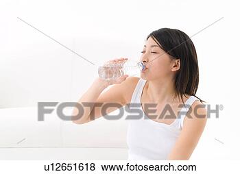 Stock Photo - young woman drinking 
water. fotosearch 
- search stock 
photos, pictures, 
images, and photo 
clipart