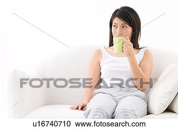 Stock Photography - young woman drinking 
coffee. fotosearch 
- search stock 
photos, pictures, 
images, and photo 
clipart