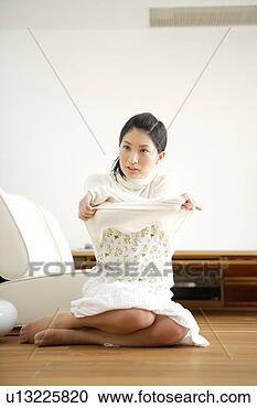 Stock Photography - young woman getting 
dressed. fotosearch 
- search stock 
photos, pictures, 
images, and photo 
clipart