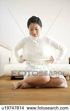 Stock Photo - young woman getting 
dressed. fotosearch 
- search stock 
photos, pictures, 
images, and photo 
clipart