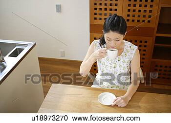 Stock Photography - young woman having 
coffee. fotosearch 
- search stock 
photos, pictures, 
images, and photo 
clipart