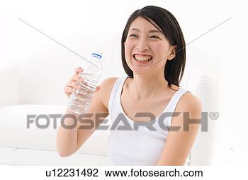 Stock Photo - young woman holding 
water bottle. 
fotosearch - search 
stock photos, 
pictures, images, 
and photo clipart