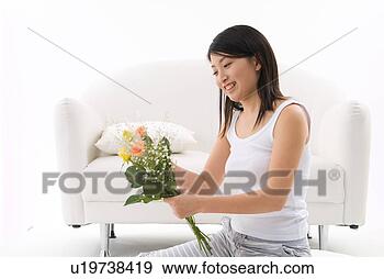 Stock Photograph - young woman holding 
flowers. fotosearch 
- search stock 
photos, pictures, 
images, and photo 
clipart