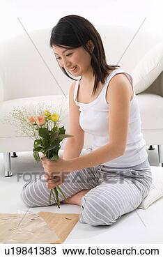 Stock Photo - young woman holding 
flowers. fotosearch 
- search stock 
photos, pictures, 
images, and photo 
clipart