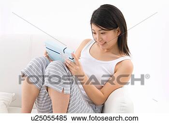 Stock Image - young woman holding 
gift. fotosearch 
- search stock 
photos, pictures, 
images, and photo 
clipart