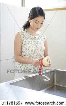 Picture - young woman peeling 
apple. fotosearch 
- search stock 
photos, pictures, 
images, and photo 
clipart