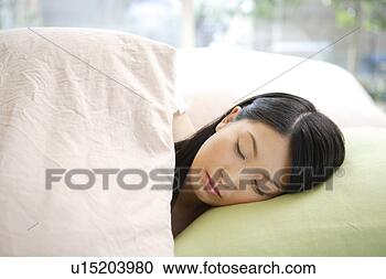 Stock Photography - young woman sleeping 
in bed. fotosearch 
- search stock 
photos, pictures, 
images, and photo 
clipart