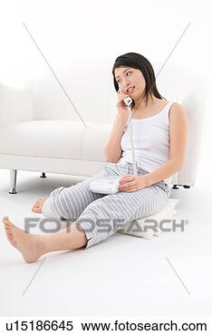 Stock Image - young woman talking 
on phone. fotosearch 
- search stock 
photos, pictures, 
images, and photo 
clipart