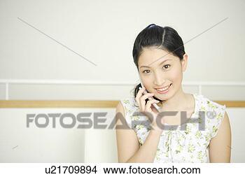 Stock Photo - young woman talking 
on mobile phone. 
fotosearch - search 
stock photos, 
pictures, images, 
and photo clipart