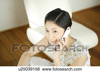 Stock Photo - young woman talking 
on mobile phone. 
fotosearch - search 
stock photos, 
pictures, images, 
and photo clipart