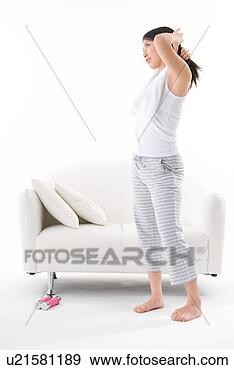 Stock Photograph - young woman tying 
up her hair. fotosearch 
- search stock 
photos, pictures, 
images, and photo 
clipart