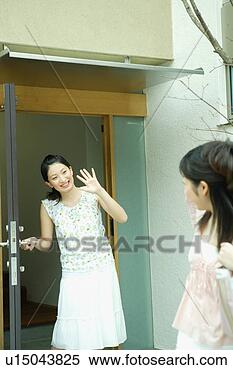 Stock Image - young woman waving 
goodbye to friend. 
fotosearch - search 
stock photos, 
pictures, images, 
and photo clipart