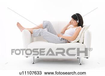 Stock Photo - young woman wearing 
headphones. fotosearch 
- search stock 
photos, pictures, 
images, and photo 
clipart