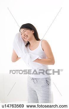 Stock Photograph - young woman wiping 
her face with 
towel. fotosearch 
- search stock 
photos, pictures, 
images, and photo 
clipart