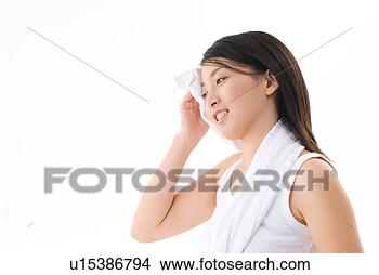 Stock Photo - young woman wiping 
her face with 
towel. fotosearch 
- search stock 
photos, pictures, 
images, and photo 
clipart