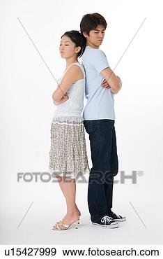 Stock Photograph - young couple standing 
back to back. 
fotosearch - search 
stock photos, 
pictures, images, 
and photo clipart
