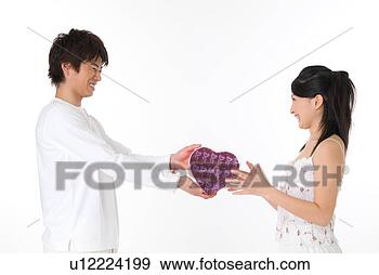 Stock Photograph - young man giving 
a present to his 
girlfriend. fotosearch 
- search stock 
photos, pictures, 
images, and photo 
clipart