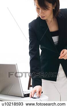 Stock Photo - a mid adult woman 
using computer. 
fotosearch - search 
stock photos, 
pictures, images, 
and photo clipart