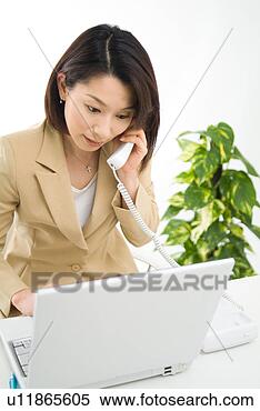 Stock Image - a mid adult woman 
talking over phone. 
fotosearch - search 
stock photos, 
pictures, images, 
and photo clipart