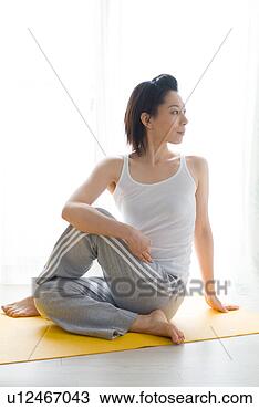 Stock Photo - a mid adult woman 
stretching. fotosearch 
- search stock 
photos, pictures, 
images, and photo 
clipart