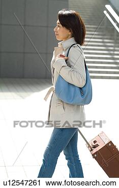 Stock Photography - a mid adult woman 
pulling suitcase. 
fotosearch - search 
stock photos, 
pictures, images, 
and photo clipart