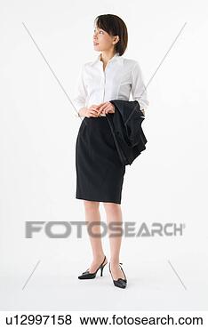 Stock Photo - a mid adult woman 
wearing suit standing. 
fotosearch - search 
stock photos, 
pictures, images, 
and photo clipart