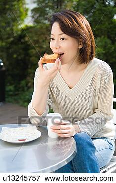 Picture - a mid adult woman 
eating toast. 
fotosearch - search 
stock photos, 
pictures, images, 
and photo clipart